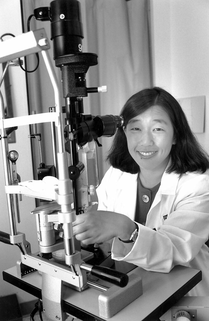 Scientist working at a microscope in a research setting