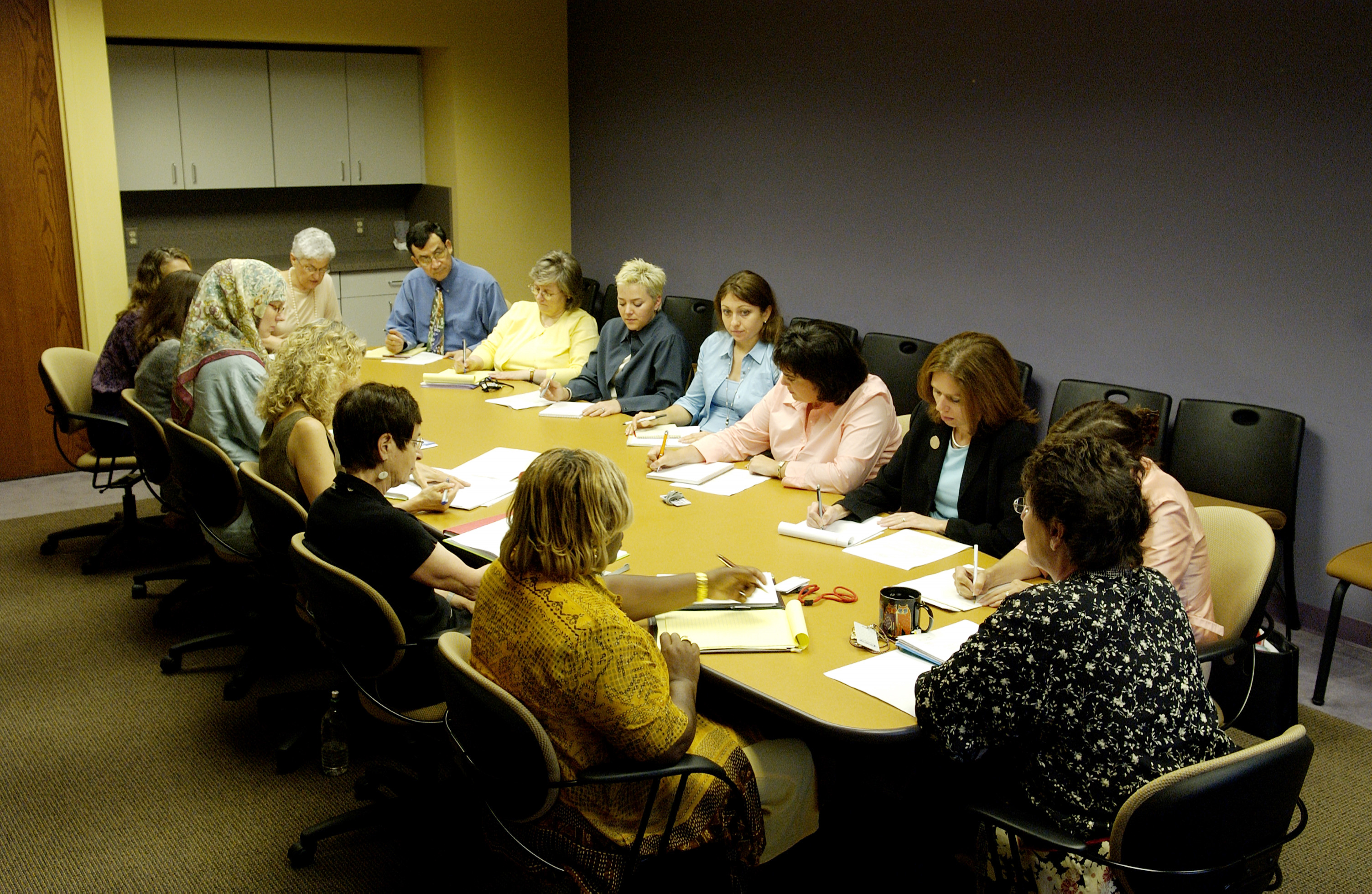 People meeting around a table in a support-group style setting